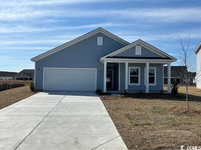 View of front of home featuring a porch, concrete 