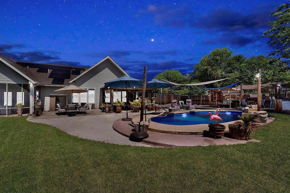 View of swimming pool featuring a patio area, a f