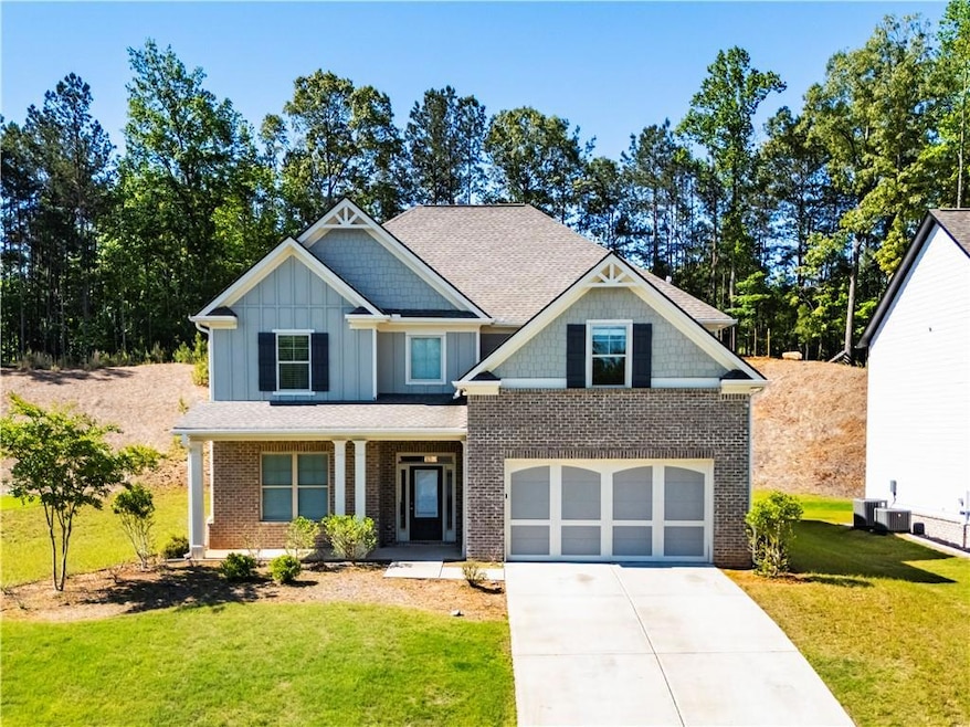 Craftsman inspired home featuring a garage, concre