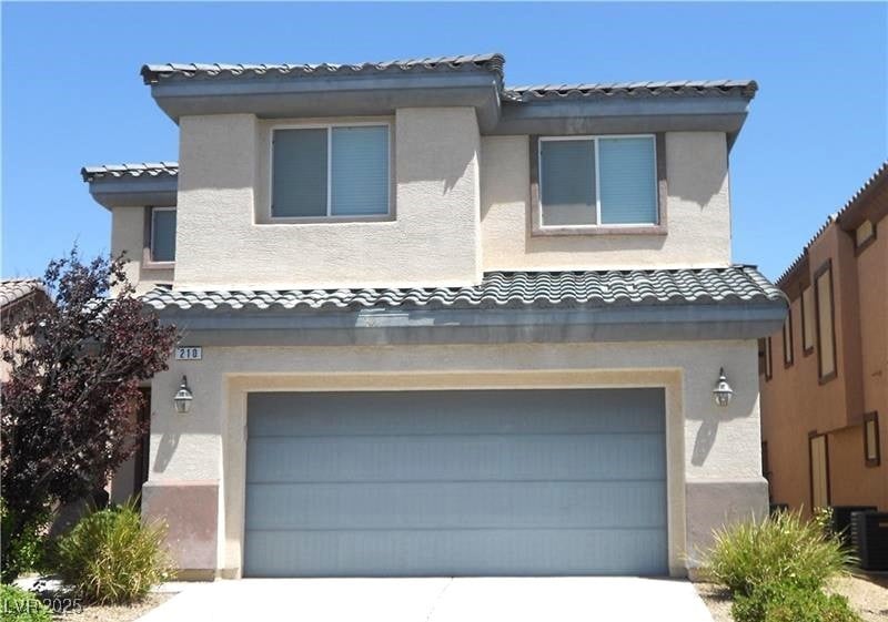 Mediterranean / spanish-style house with a tiled roof, an attached garage, stucco siding, and concrete driveway