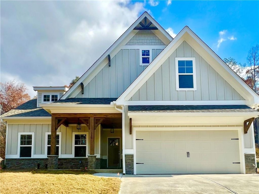 Craftsman-style home with a front yard and a garage