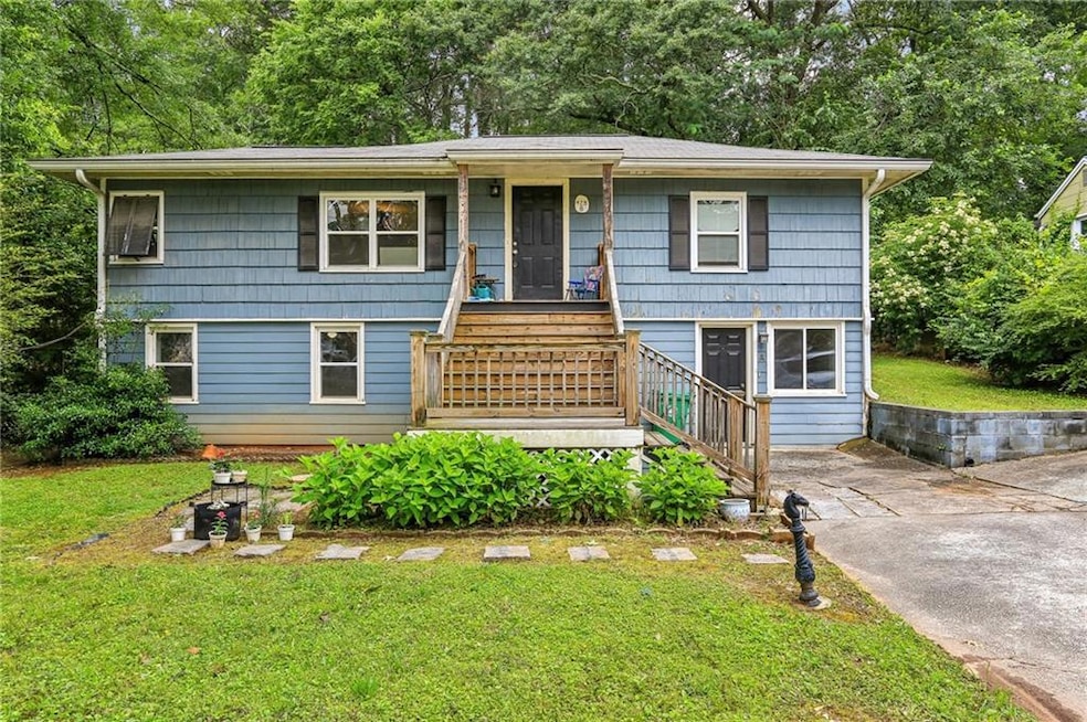 View of front of property with stairs and a front lawn