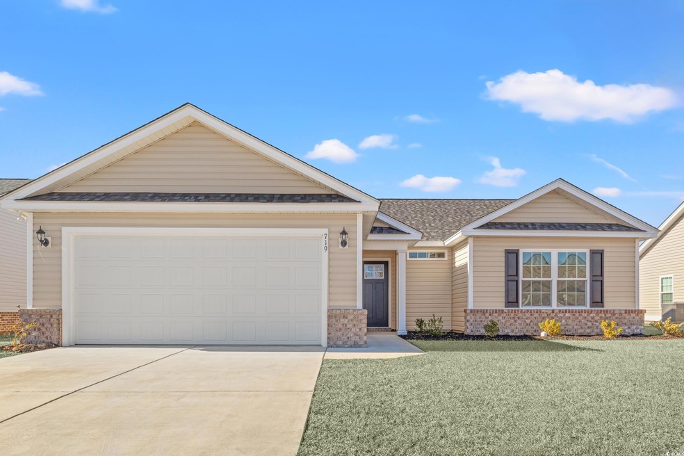 View of front of home featuring a front lawn and a garage