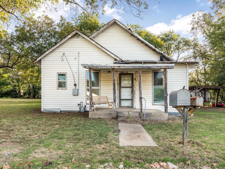 Bungalow-style house with a front yard and covered