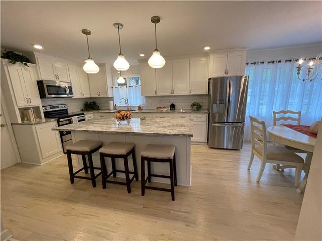All new kitchen with custom cabinets, island, gran