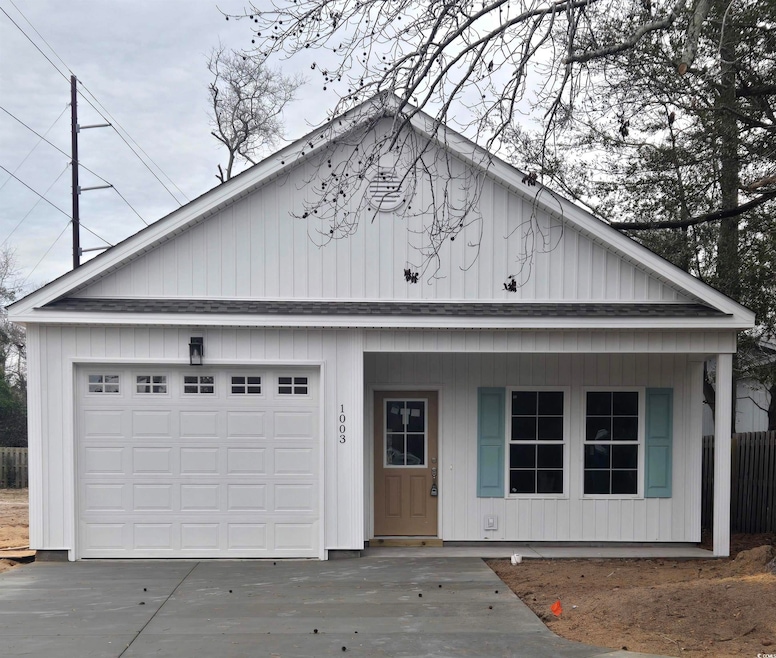 View of front facade featuring a garage