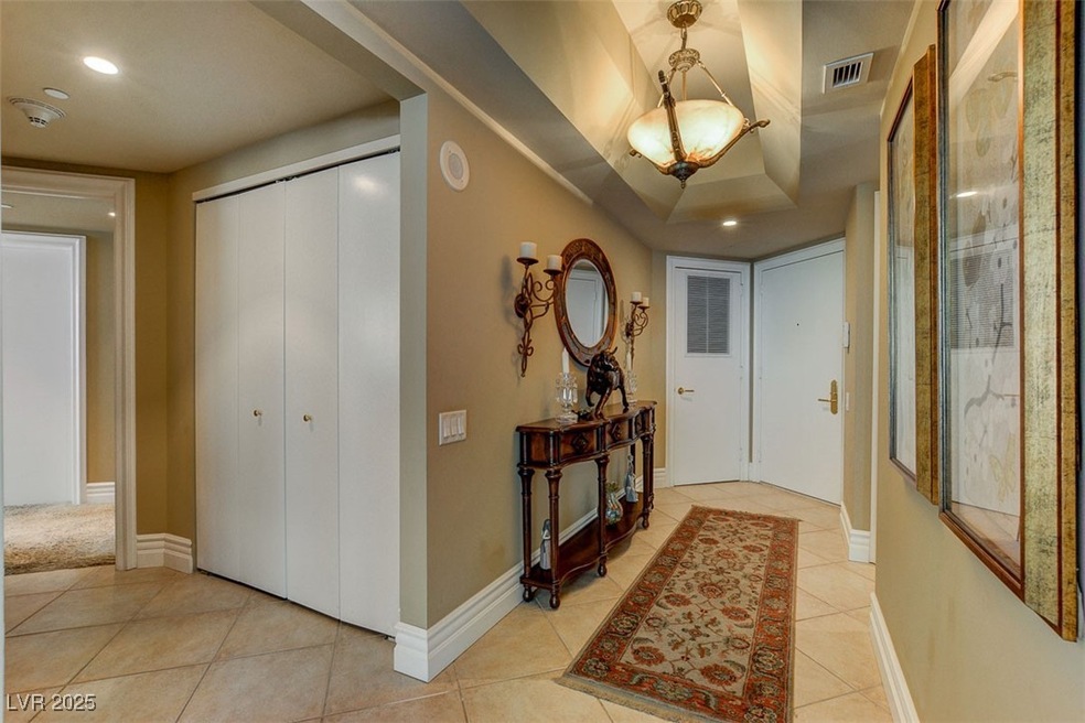 Hallway with baseboards, recessed lighting, light