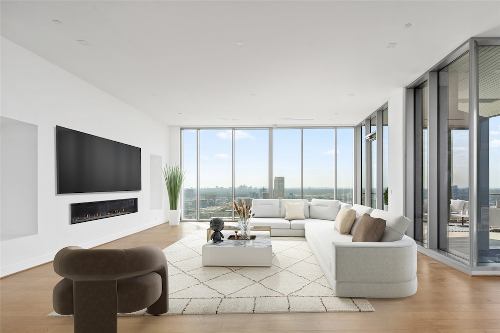 Living room features sweeping views of the sky lin