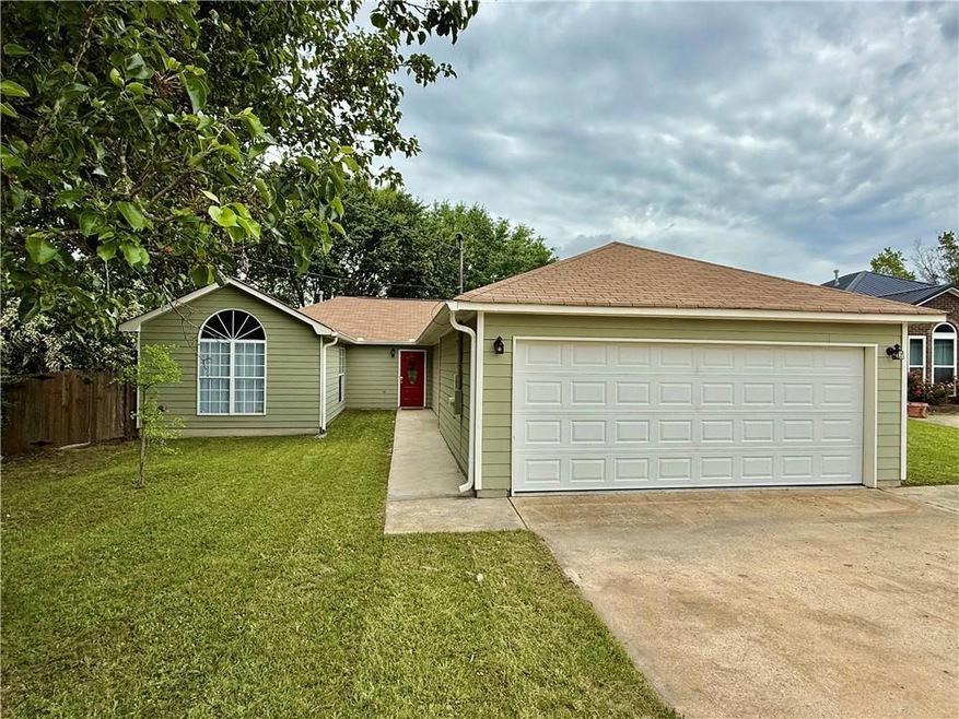 Ranch-style house with fence, driveway, and a fron