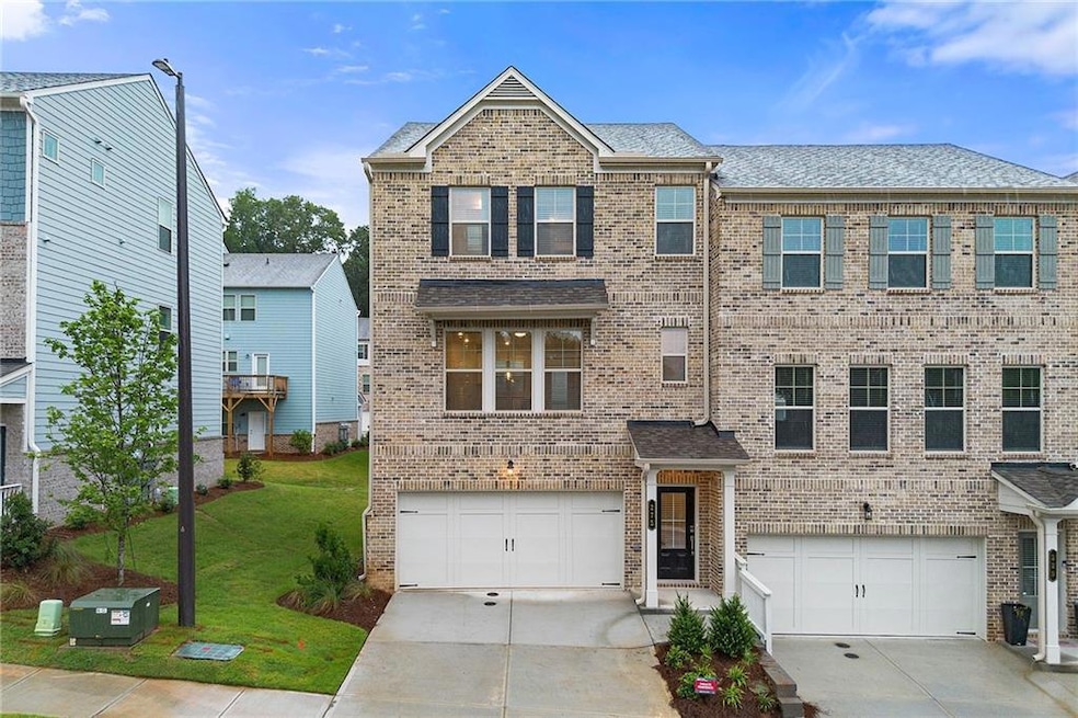 View of front of property with a garage and a front yard