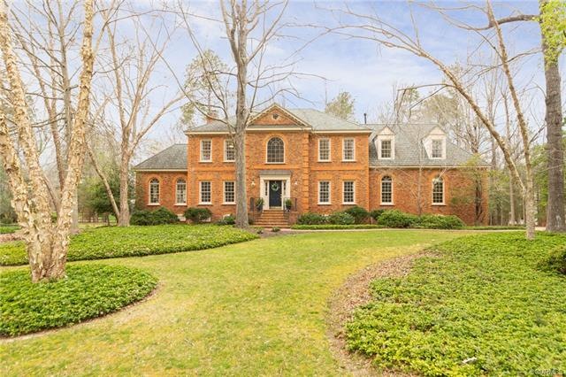 Front of the home with manicured landscaping.