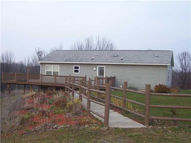 Exterior Front. Wrap around deck provides plenty o