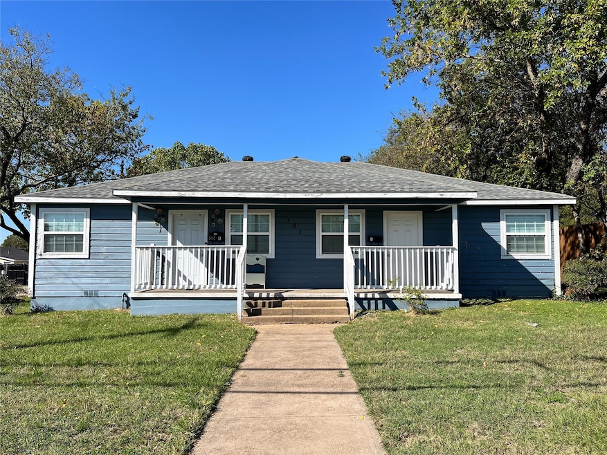 View of front of home featuring covered porch, a f