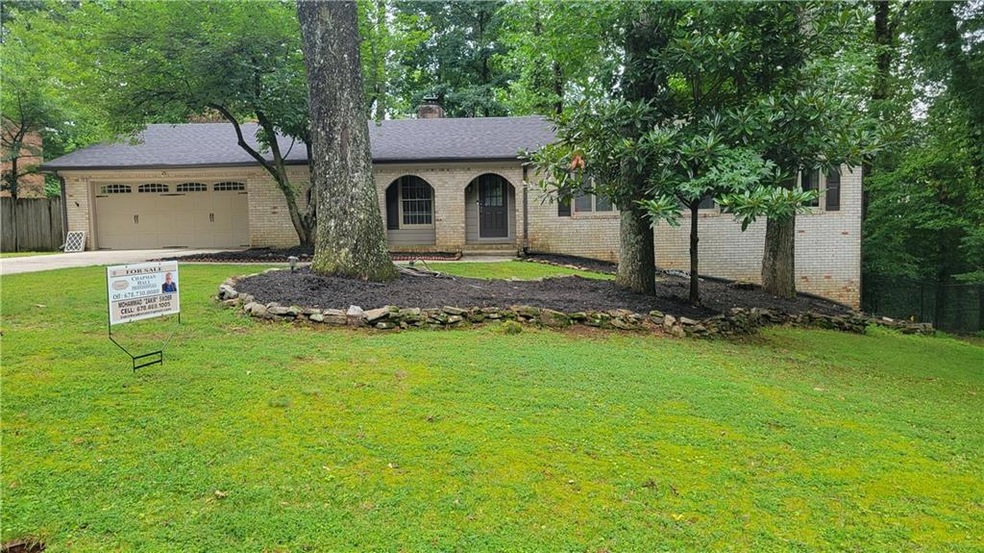Single story home featuring a garage and a front y
