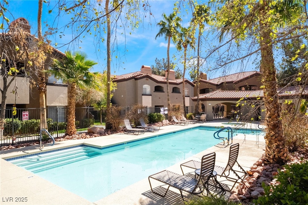 Pool featuring fence and a patio