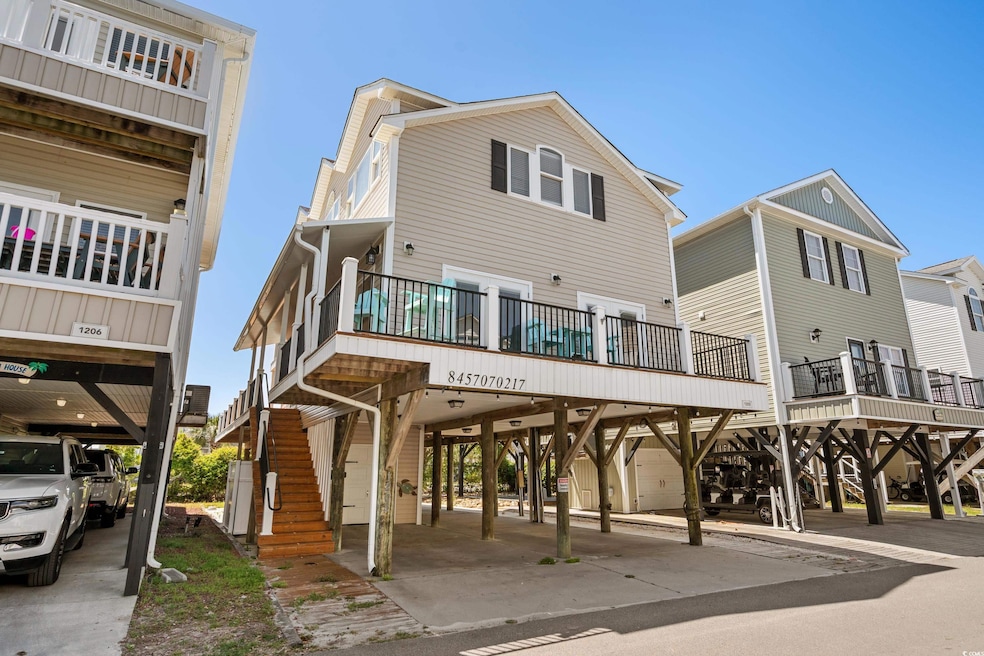 View of front of property with a carport and stair