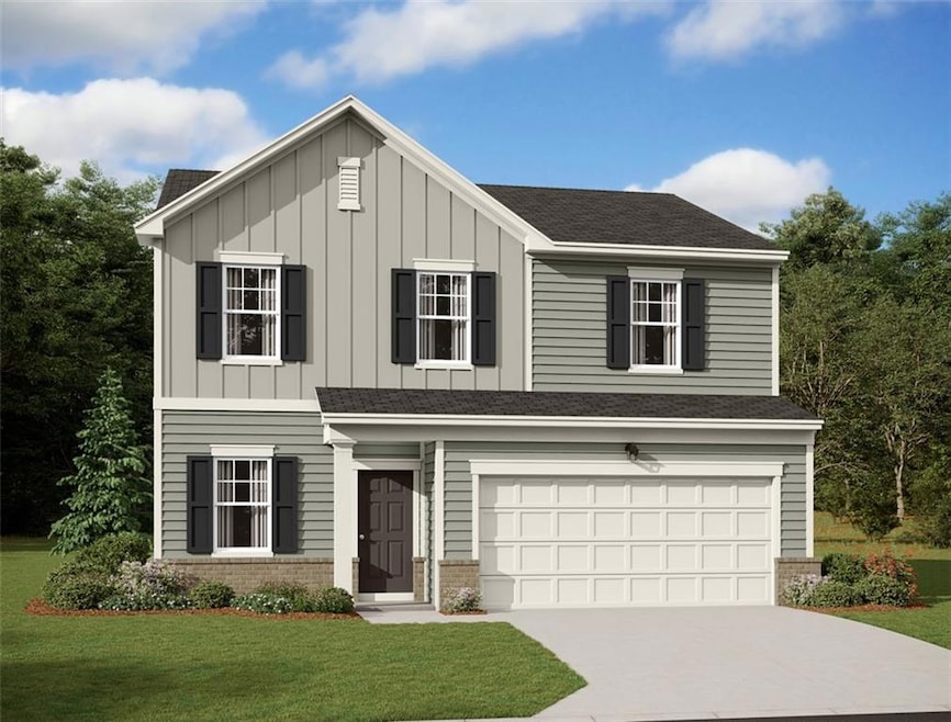 View of front of property with a garage and a front lawn