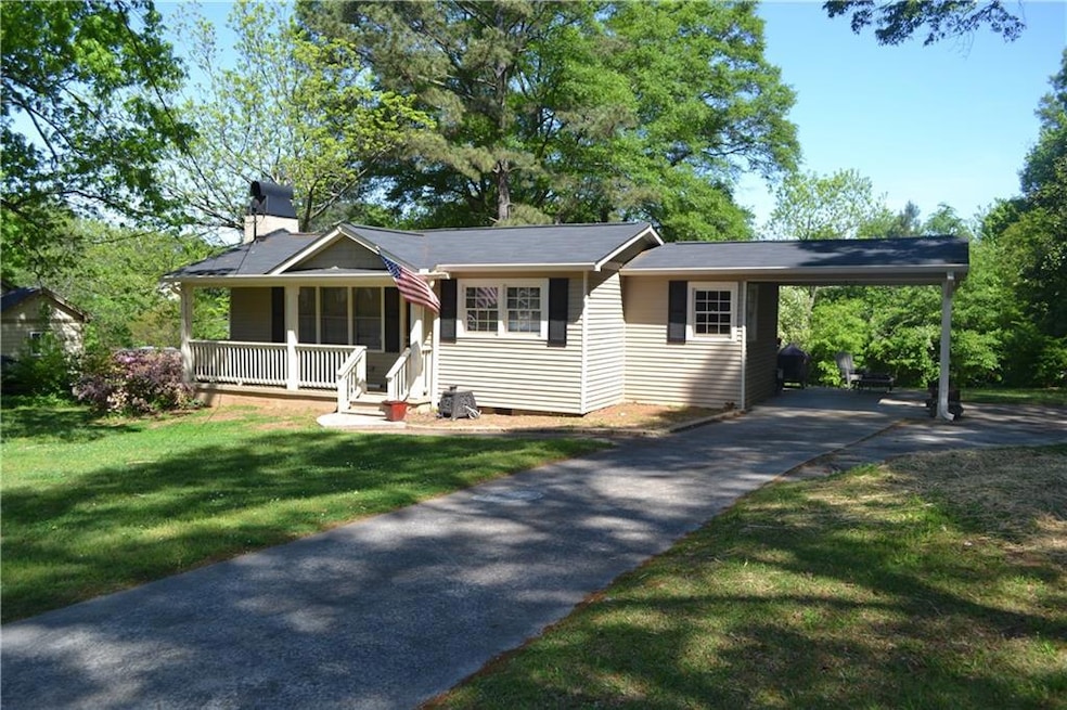 View of front of home with a front yard, a porch, 