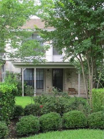 Covered rear patio overlooking spacious greenery a