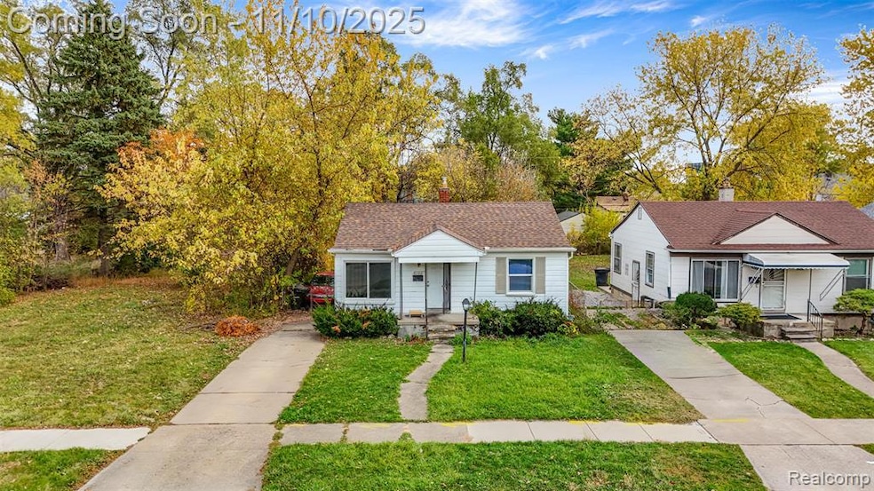 Bungalow featuring a front yard, a chimney, and a shingled roof