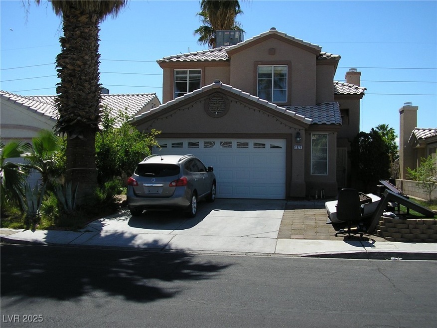 View of front of home with a tile roof, driveway,