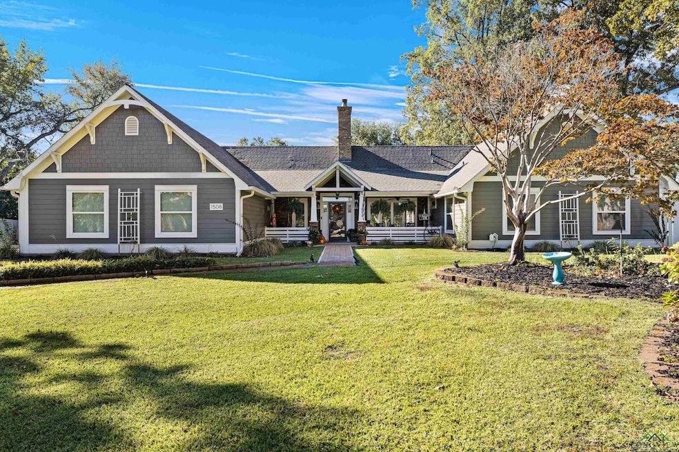 View of front of home with a porch and a front yar