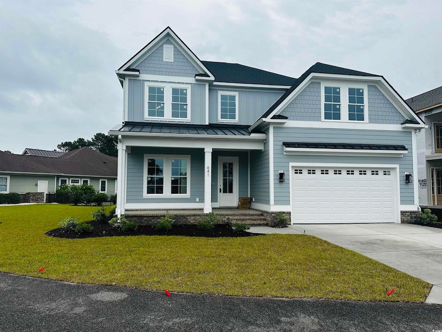 View of front facade featuring driveway, a standin