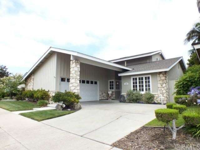 Front of house faces west showing large cement dri