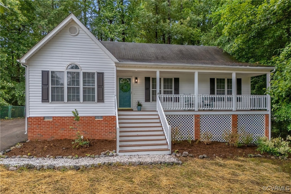 View of front of home featuring crawl space, cover