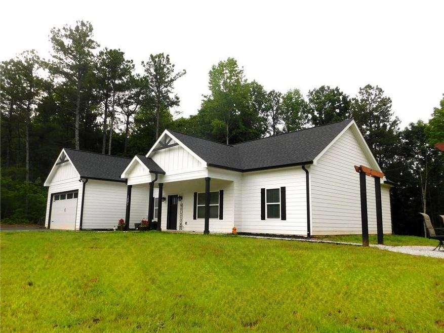 Modern farmhouse style home featuring a front yard