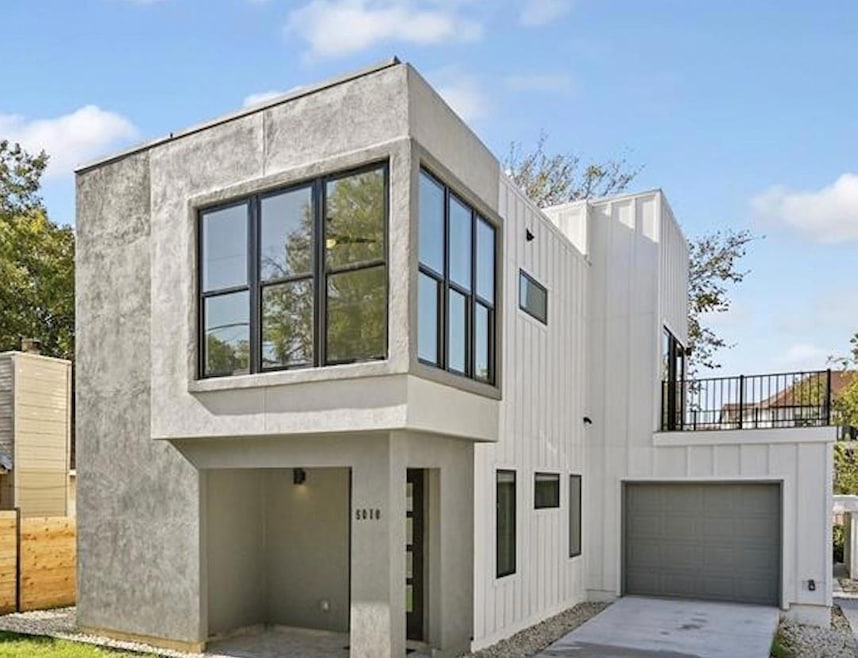 View of property exterior featuring concrete driv