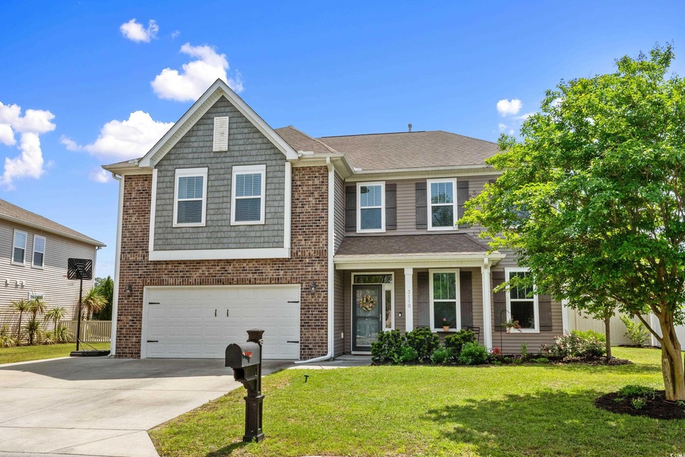 View of front of home featuring concrete driveway, a garage, a front lawn, a porch, and roof with shingles