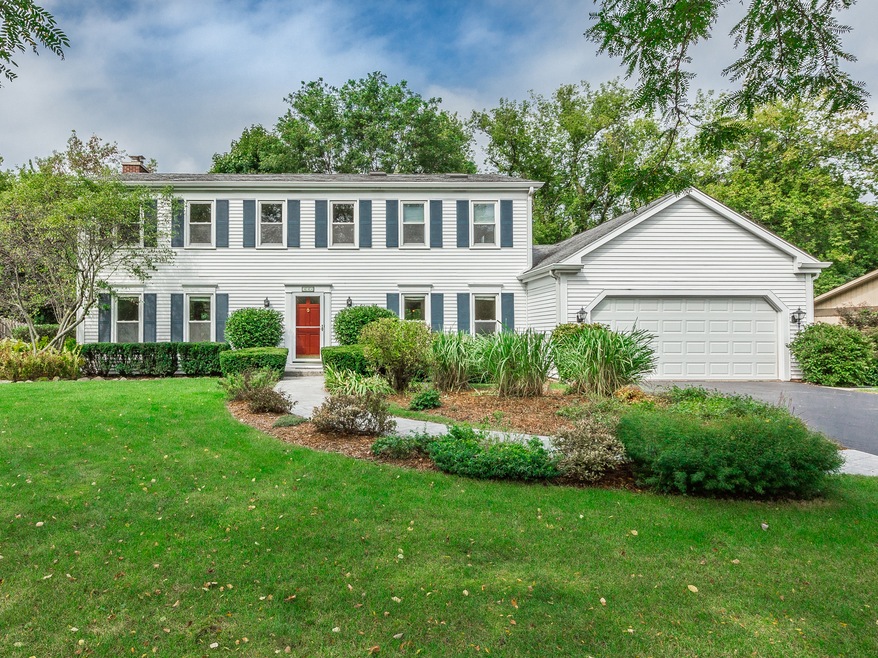 Gorgeous perennial gardens flank the front walkway