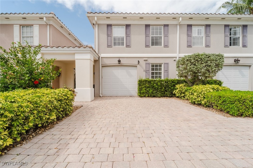 View of front of home with decorative driveway, a