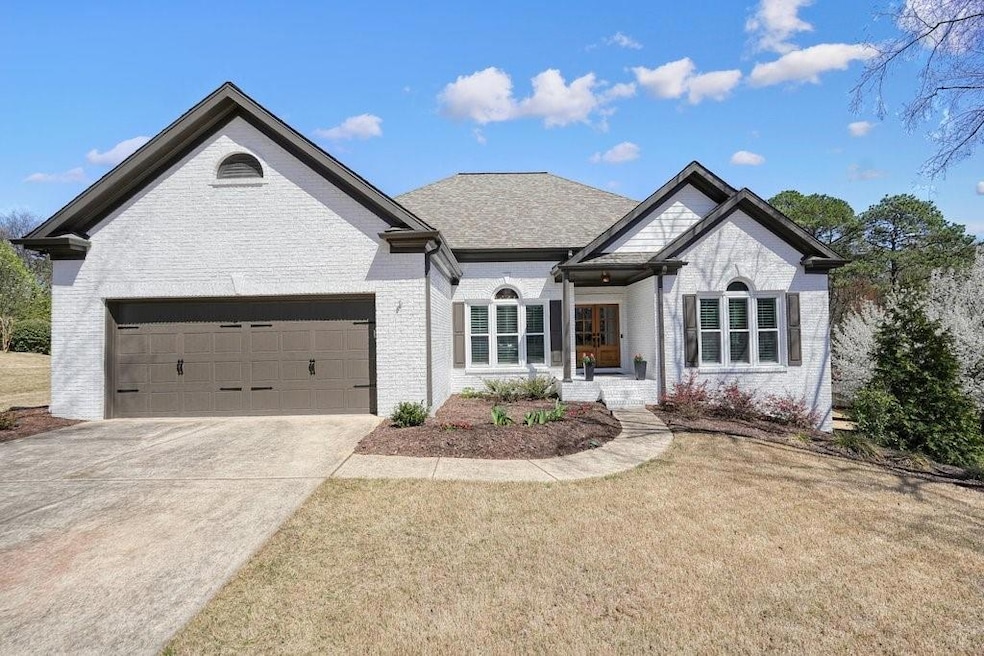 French country inspired facade with brick siding, 