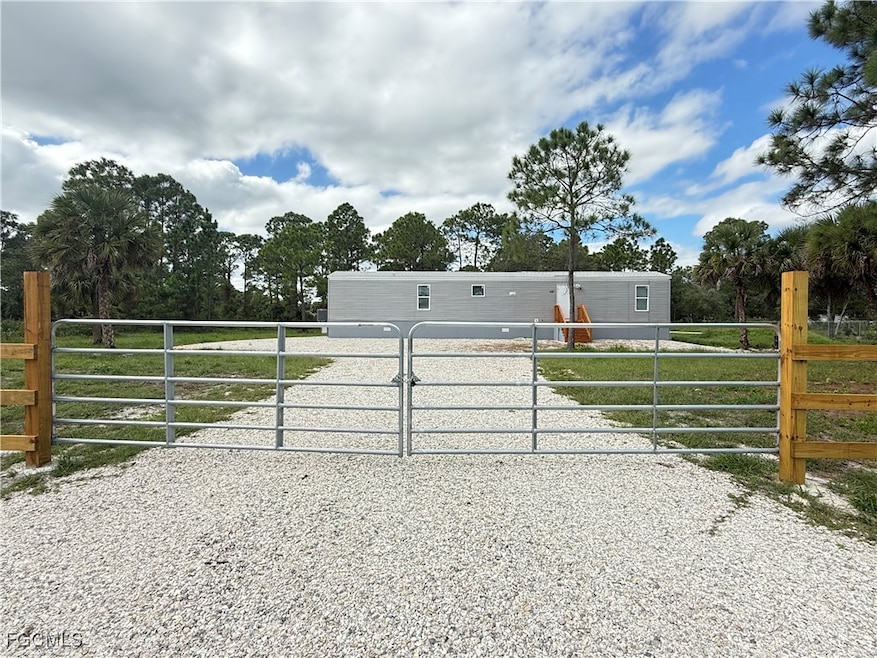 Gate featuring view of wooded area