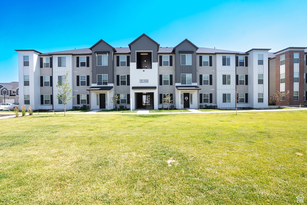 View of front of property featuring a front yard and stucco siding