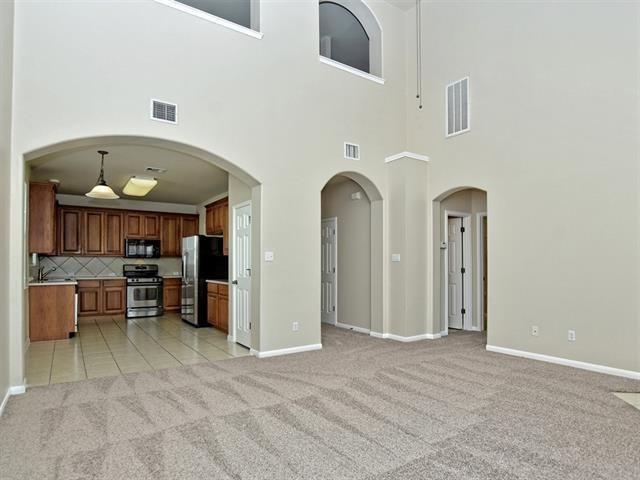 Living room features new carpet, paint, vaulted ce