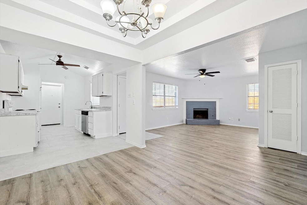 Unfurnished living room featuring ceiling fan with