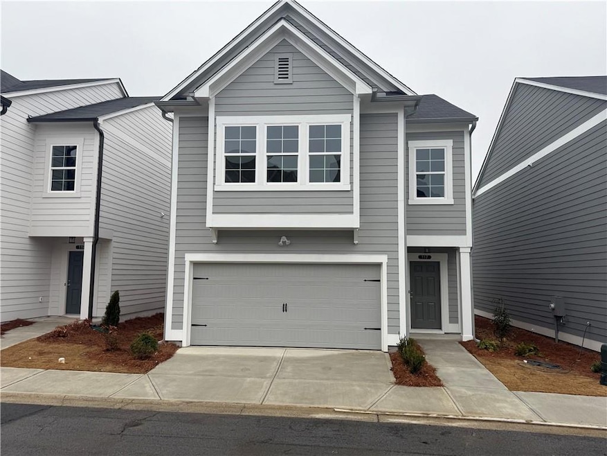 View of front of home featuring concrete driveway 