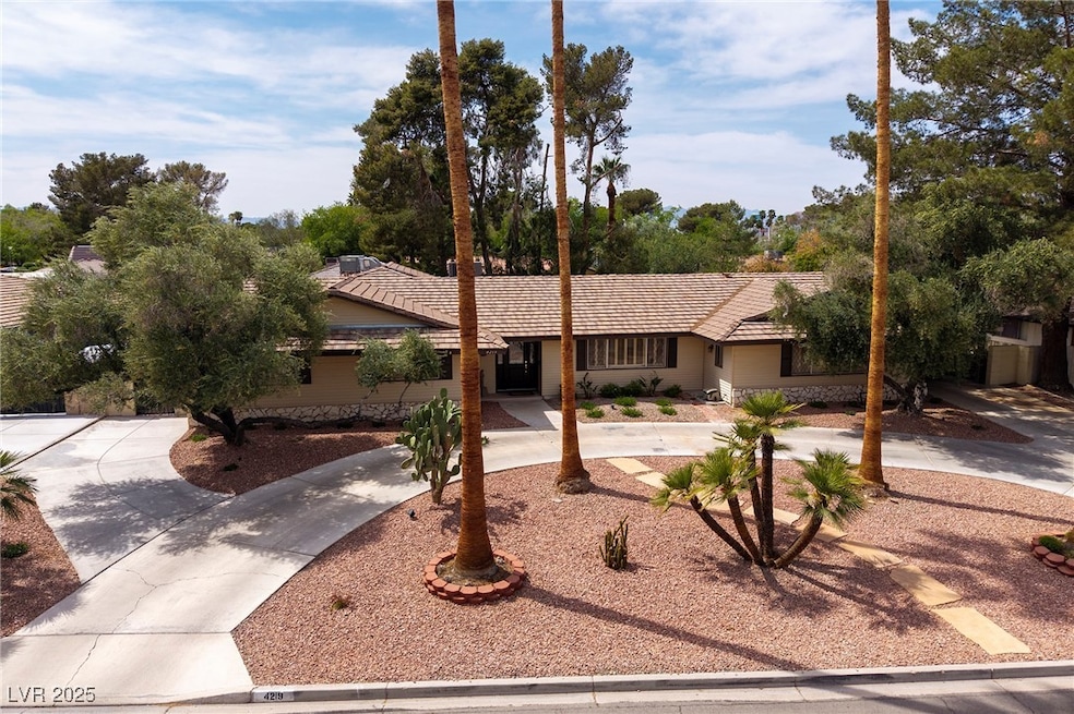 Ranch-style house featuring a tiled roof and curve