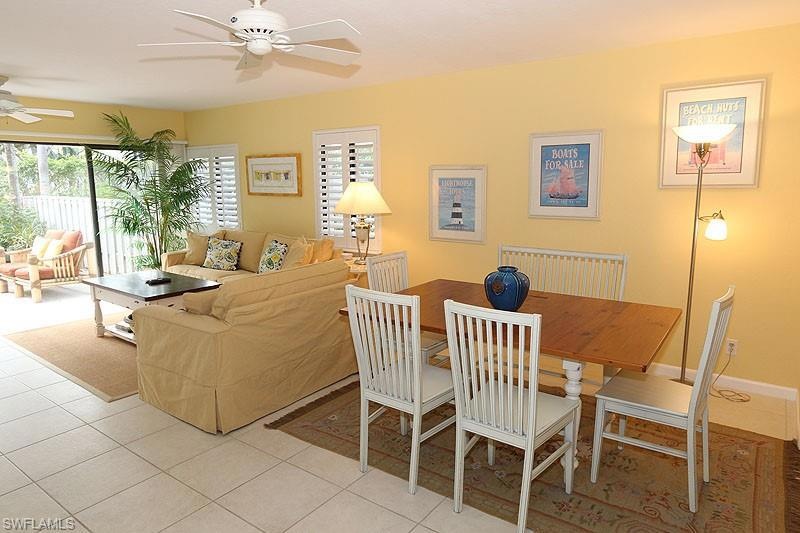 Dining area featuring ceiling fan and light tile patterned flooring