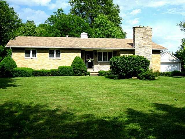 Exterior Front. Brick hillside ranch on almost 3 g