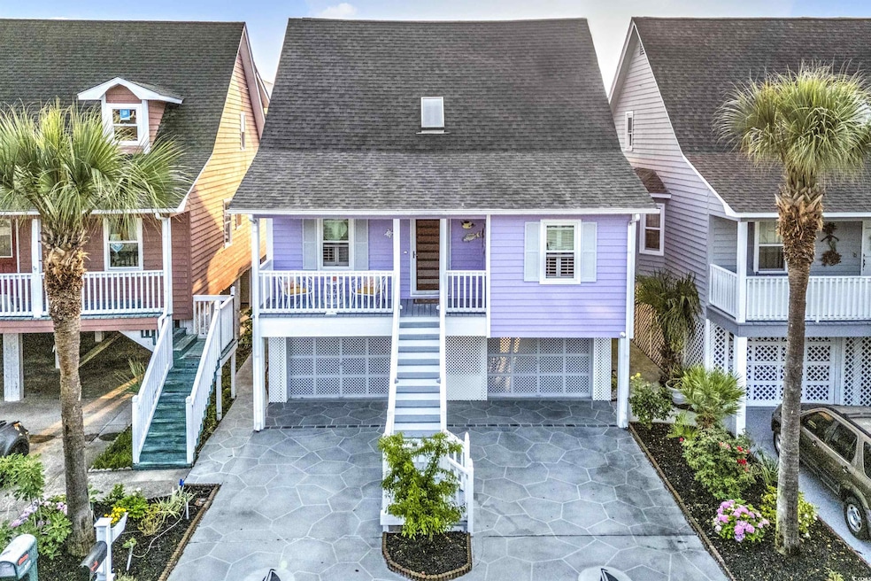 Coastal inspired home featuring stairway, concrete driveway, a shingled roof, a porch, and a garage