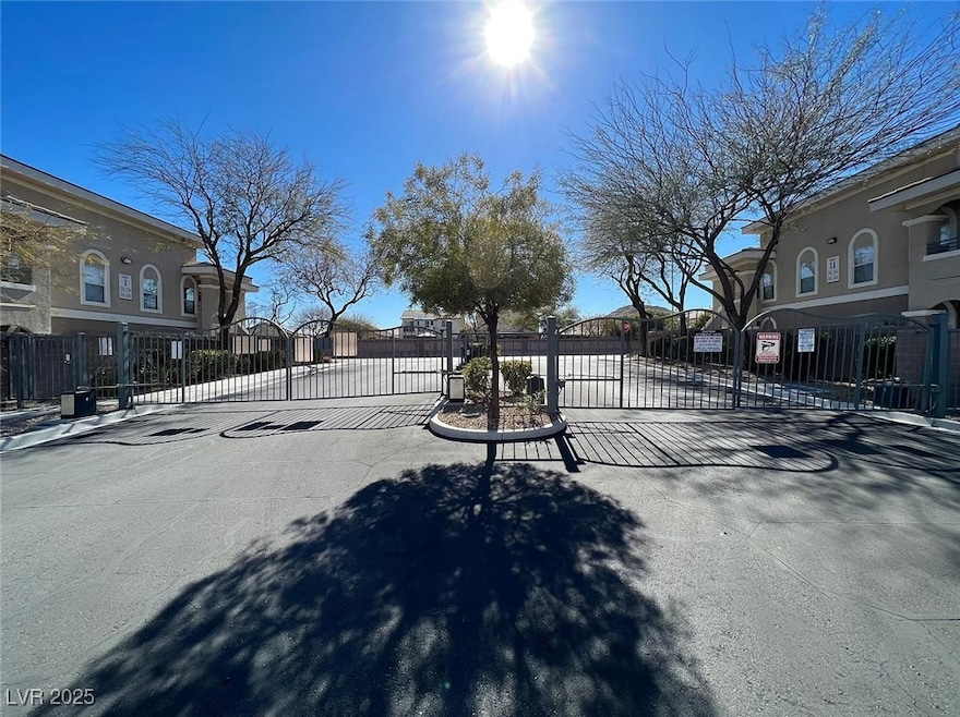 View of road with a gated entry, a gate, a residen