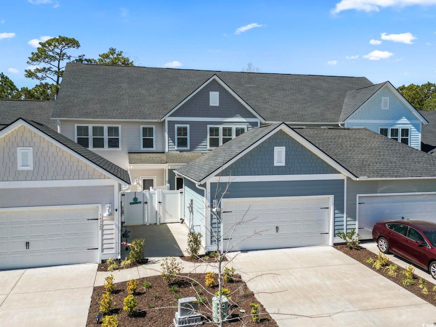 View of front of property with a garage, roof with
