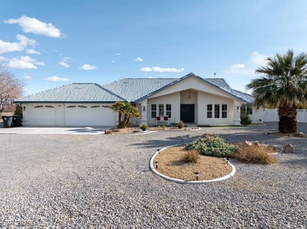 Ranch-style home featuring driveway, an attached g