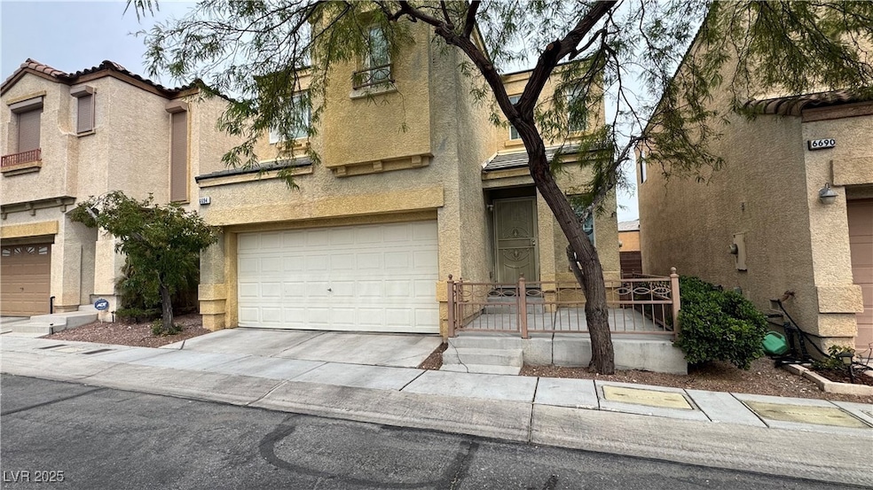 Mediterranean / spanish-style house featuring stucco siding, a wooden deck, a tile roof, driveway, and a garage