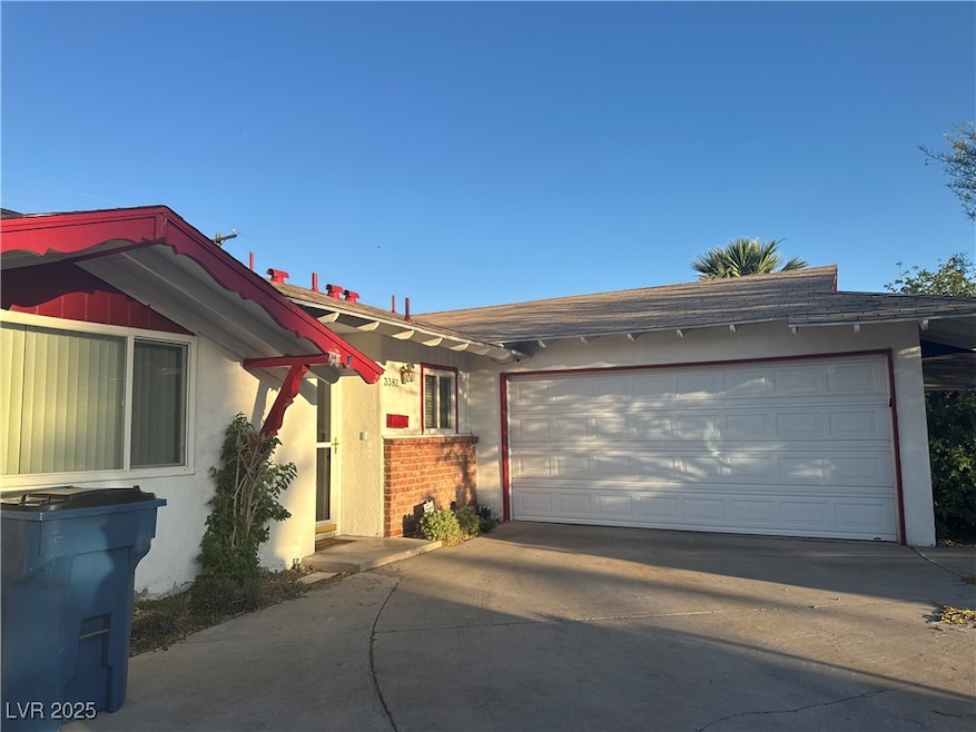 Ranch-style home featuring concrete driveway, stuc