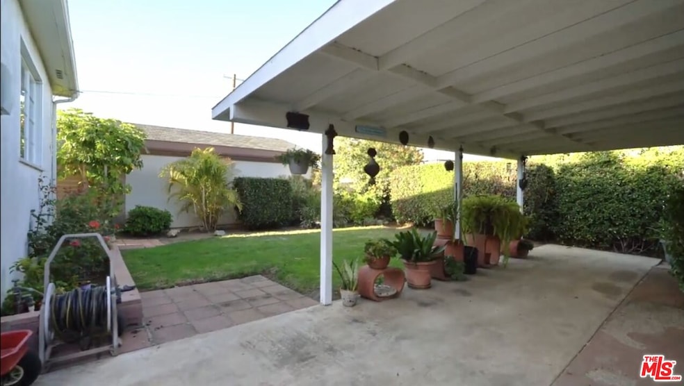Covered Patio in backyard attached to the garage